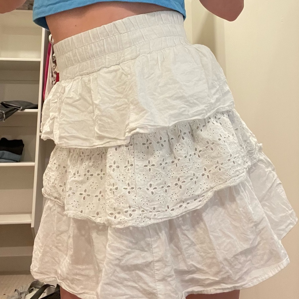 White frilly eyelet mini skirt. Perfect for summer and breathable material.